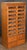 A handsome vintage double haberdashery or haberdasher's cabinet of patinated oak, with paneled sides from England...