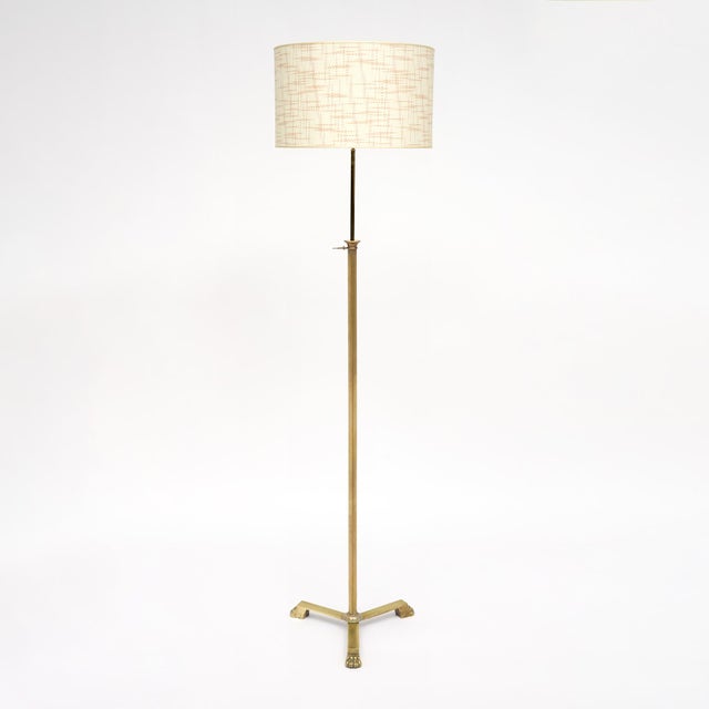Floor lamp from the Art Deco period in France. This piece is made with a ridged brass stem while the tripod foot is of...