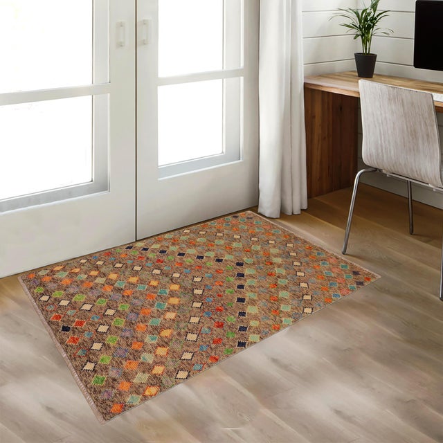 A mesmerizing addition to any decor, this exhilarating hand-knotted rug featuring exquisite coloration in an intricate...