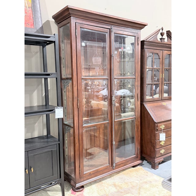 This stately rustic display cabinet blends timeless craftsmanship with refined architectural details, creating a...