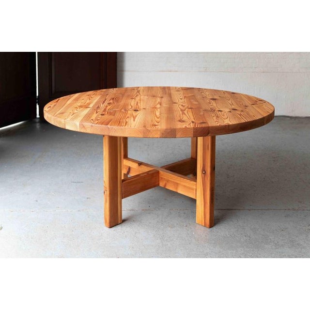 This round solid pine table was designed by Roland Wilhelmsson and produced by Karl Andersson & Söner in Denmark, during...