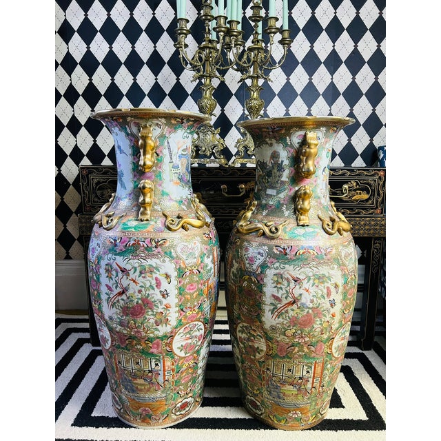 Gigantic pair of Chinese porcelain floor vases featuring famille rose decoration with hand-painted figural court scenes,...