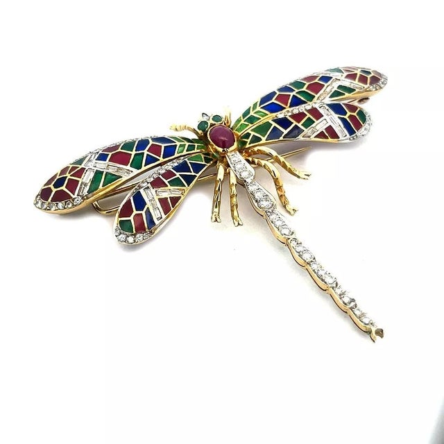 This is a magnificent brooch. It features an 18k yellow gold large dragonfly with multicolor enamel plique-a-jour wings...