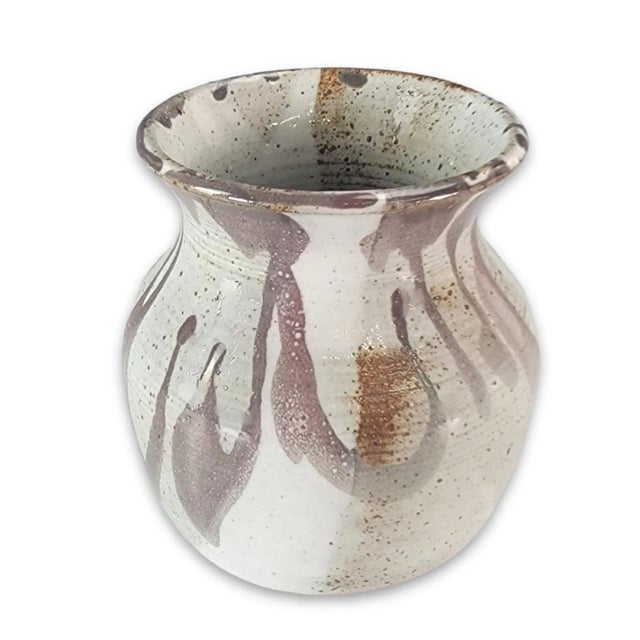 A study in earth, fire, and form, this 5-inch Raku vase bears the marks of both the artist’s hand and the unpredictability...