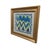 A vibrant, one-of-a-kind textile art piece featuring Schumacher’s Zig Zag Weave fabric, framed inside a metallic-gold...