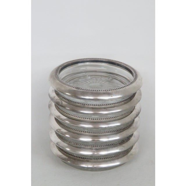 This lovely set of 6 Coasters made of metal and glass. The Coasters have crystal dish with sunburst design, with silver...