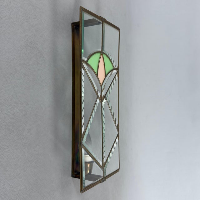 A lighting piece of exceptional rarity and refined value. This magnificent wall light is a superb testament to period...
