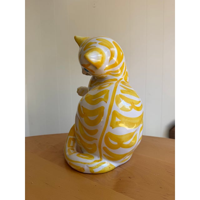 Large vintage Italian ceramic cat sculpture, approximately 16” tall, with a whimsical raised paw, curled tail, and hand-...