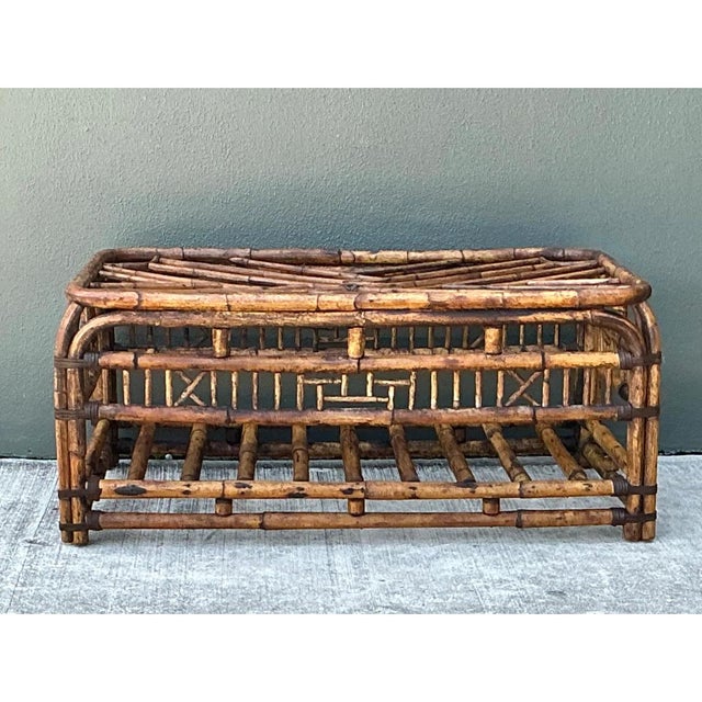 Crafted in sturdy bent rattan with leather-wrapped corner bindings, this vintage coffee table captures the exotic elegance...
