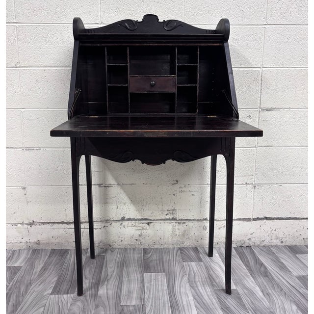 This is a gorgeous antique Victorian petite secretary desk featuring a dark finish, carved foliate crest, scalloped apron,...