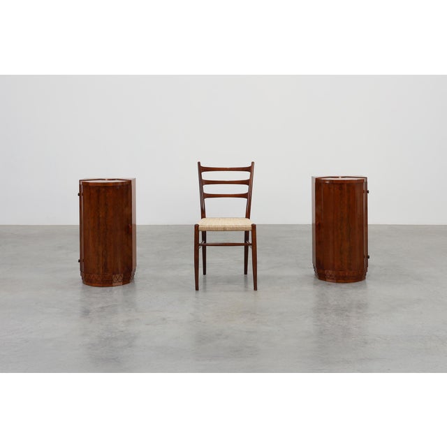 A rare and sculptural pair of Italian Art Deco nightstands, crafted in richly figured walnut circa 1920. Each piece...