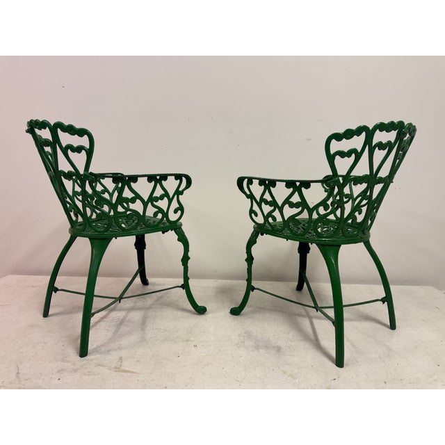 Mid-Century Cast iron Garden Dining Set An elegant mid-century cast iron garden dining set comprising an oval dining table...
