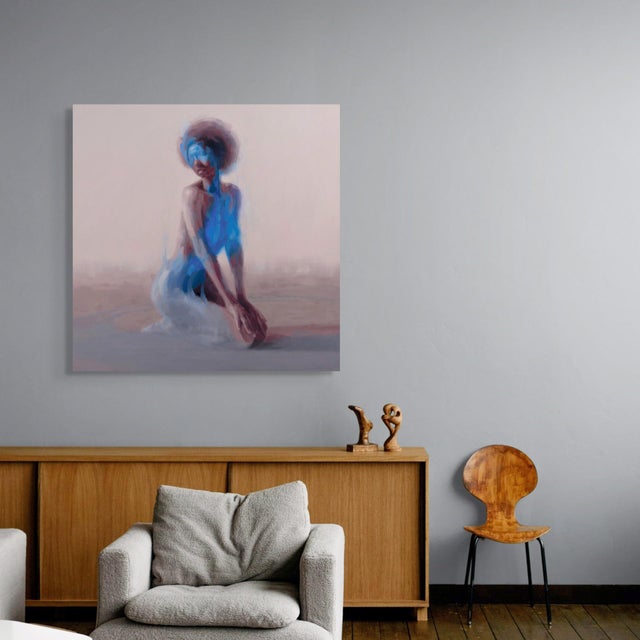The artwork depicts a solitary figure kneeling, enveloped in ethereal shades of blue that blend seamlessly with the soft,...