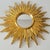 A beautiful, gold-colored sunburst mirror, made in Belgium in the 1970s. This striking mirror is designed in the shape of...