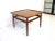 A nice well crafted teak wood square coffee table with upturned edges , conical legs attached by stretchers with small...
