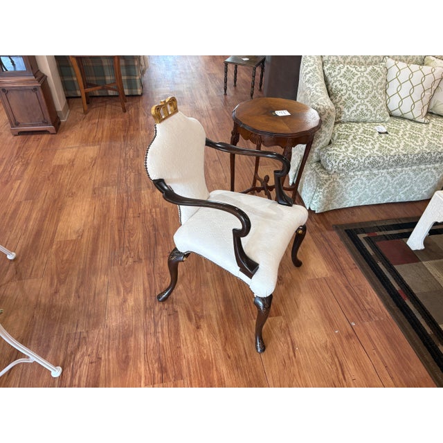 An elegant Baker Furniture Queen Anne armchair from the Stately Homes collection. This model features a fully upholstered...