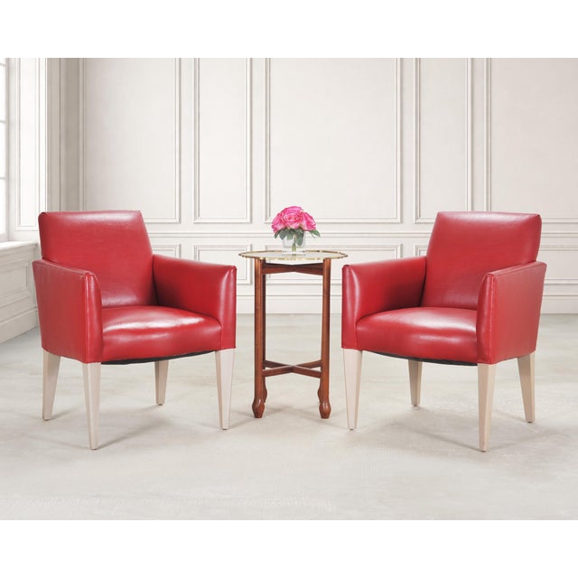 A stylish pair of Italian Art Deco style leather lounge armchairs crafted in the style of mid-century Italian furniture...