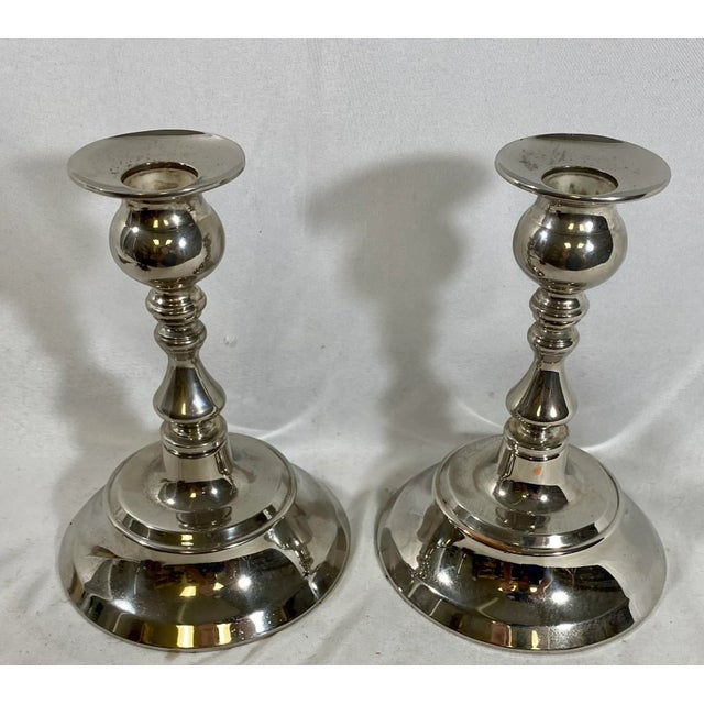 Vintage Pair of Classic Silver Plate Candlesticks From England. Each measures 4 3/4 W x 4 3/4” D x 6 1/2” T