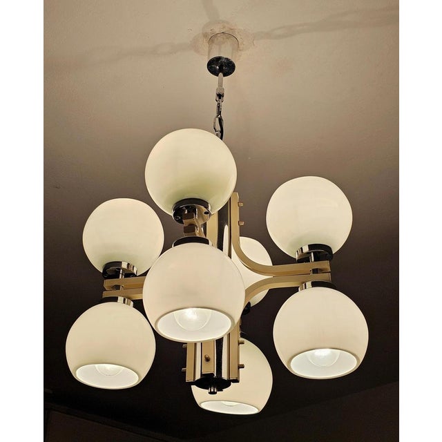 In this listing you will find a stunning Space Age 4-Arm Chandelier with 8 lights placed in white glass balls with open...