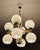 In this listing you will find a stunning Space Age 4-Arm Chandelier with 8 lights placed in white glass balls with open...