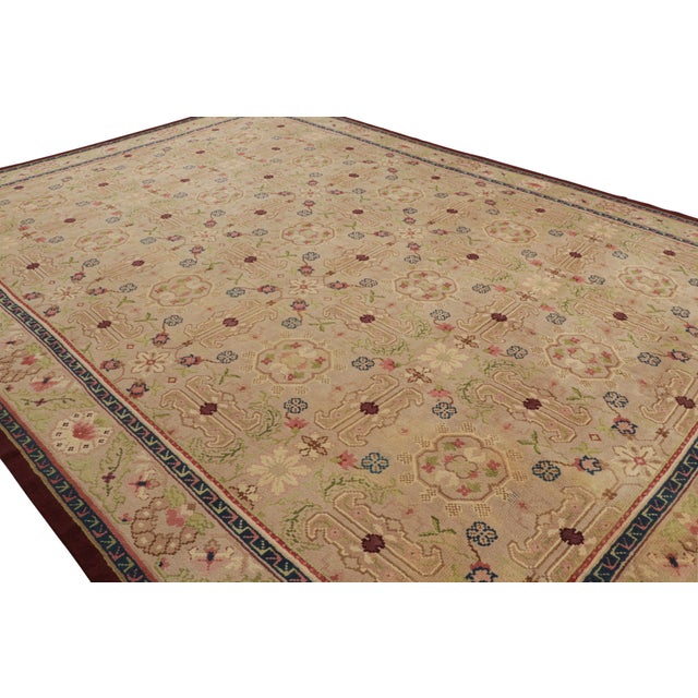 Hand-knotted in wool circa 1920, this 13x18 antique Savonnerie rug is an exciting new curation from the European rug...