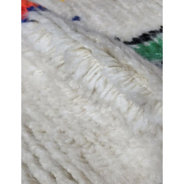 Berber Azilal Rug – Colorful Handmade Moroccan Wool Carpet This beautiful handmade Azilal rug features a playful...