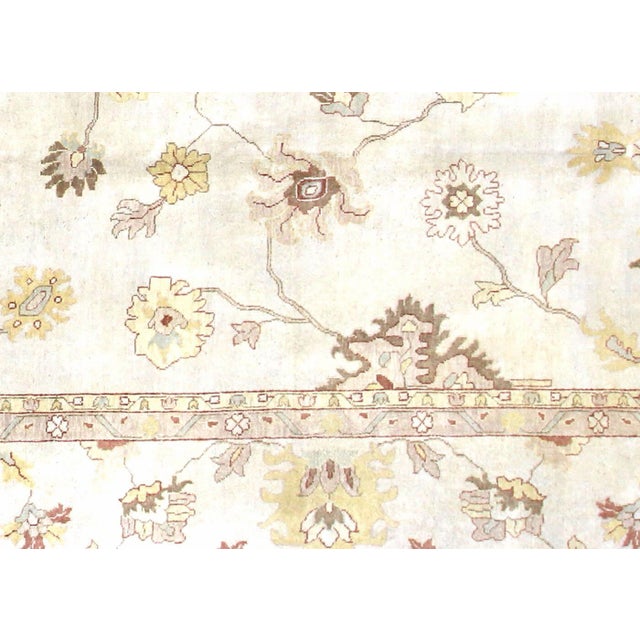 Originating from the Oushak region of Western Turkey, this substantial vintage rug represents centuries of weaving...