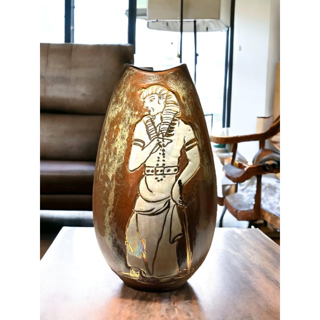 A unique hand painted copper & celadon glazed vase adorned by an image of an Egyptian pharaoh glazed in an opalescent...