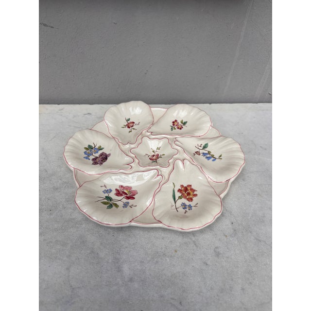 Majolica oyster plate with different flowers on each shells, circa 1900 signed Longchamp.