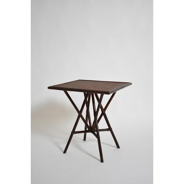 "Arrabida" brown rattan table, Barracuda edition. "Arrabida" brown rattan tea/bedside table standing on four crossed legs,...