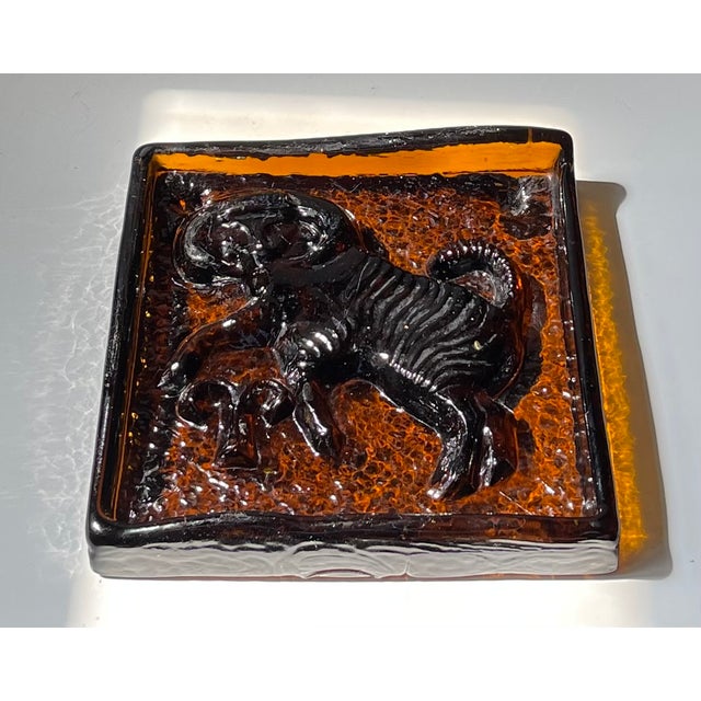 A striking Mid-Century glass object of Polish origin. Crafted from solid, cast amber colored glass. It is rectangular in...