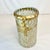 This 1980s Glass Mosaic Vase is handmade in Mexico. The cylinder has glass chips in a frosted white and old gold palette....
