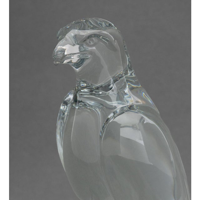 Baccarat Crystal Falcon Sculpture, the bird perched atop a rocky base, signed to side of base and marked "Baccarat France"...
