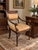 A striking Theodore Alexander armchair inspired by classical Regency and Empire design, featuring a richly finished...