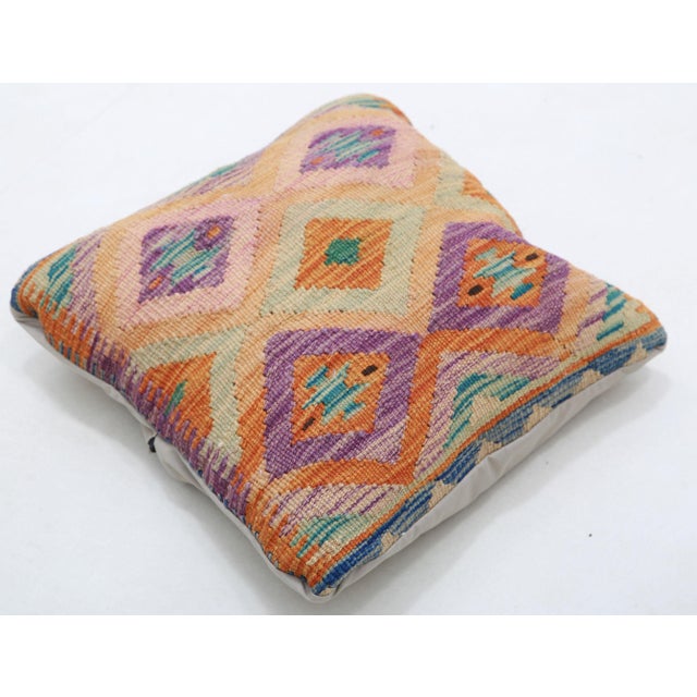 A one-of-a-kind handwoven Afghan wool kilim accent pillow featuring diamond lattice. Cut and sewn by hand from a flat-...