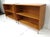 A pair of solid maple wood Mid Century bookcases each with one nonadjustable shelve sitting on squared stainless steel...