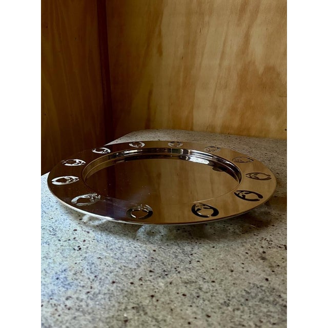 This appears to be an Alessi Girotondo silver-plated round tray, a well-known design piece with characteristic cutout...