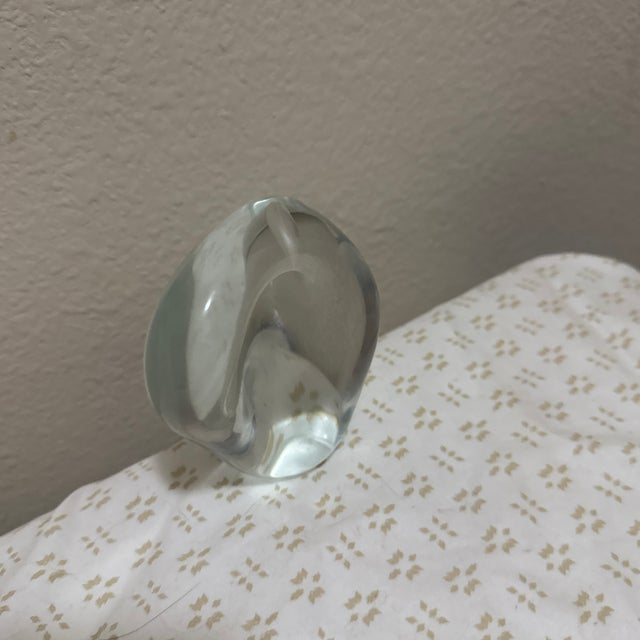 Add a touch of modern elegance to your desk or home décor with this beautiful clear glass paperweight featuring an...