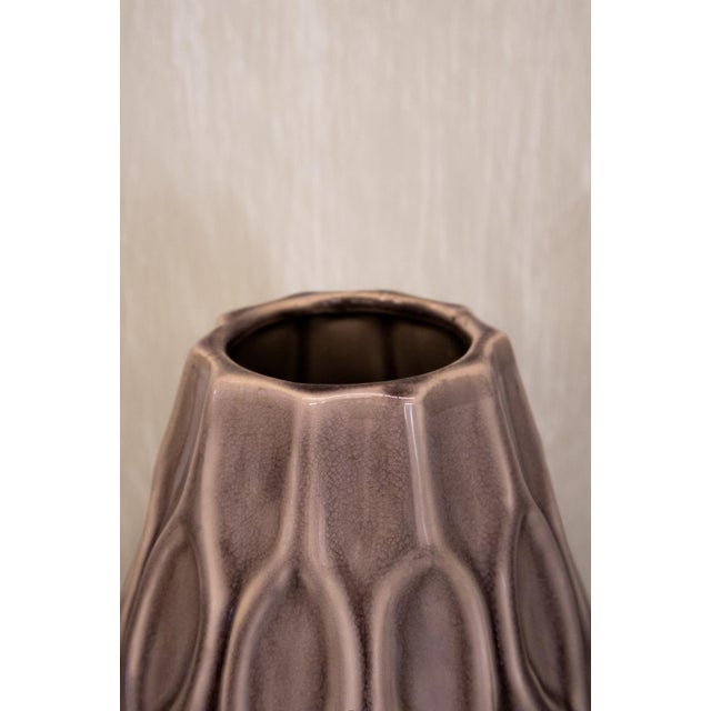 Decorative glazed ceramic vase from the 1970s, in taupe tones. Featuring an elongated, tapered form and a raised surface...