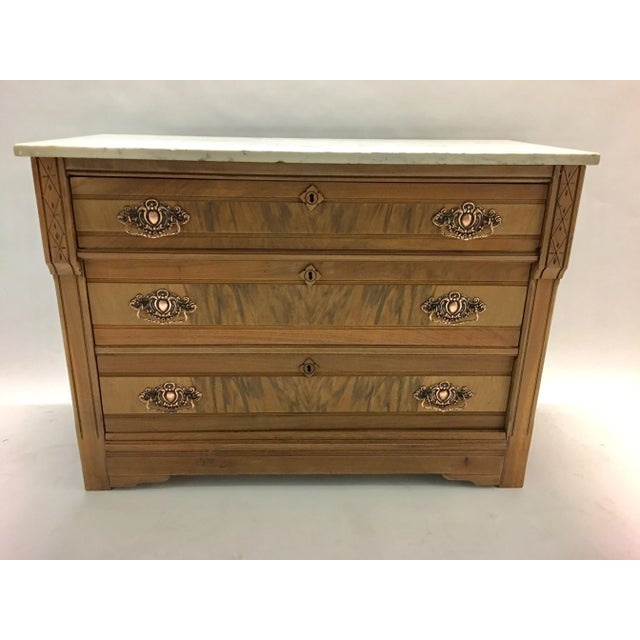 Late 1800's mahogany chest of drawers with a carerra marble top and copper hardware. Newly stripped to its natural wood....