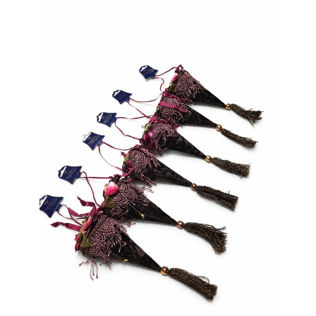 A striking set of six Christmas Traditions by Aldik ornaments featuring a rich chocolate brown palette accented with...