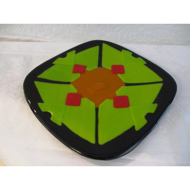 Cool mid-century decorative fused art glass dish in vibrant shades of black, lime green, orange and red. No marks. For...
