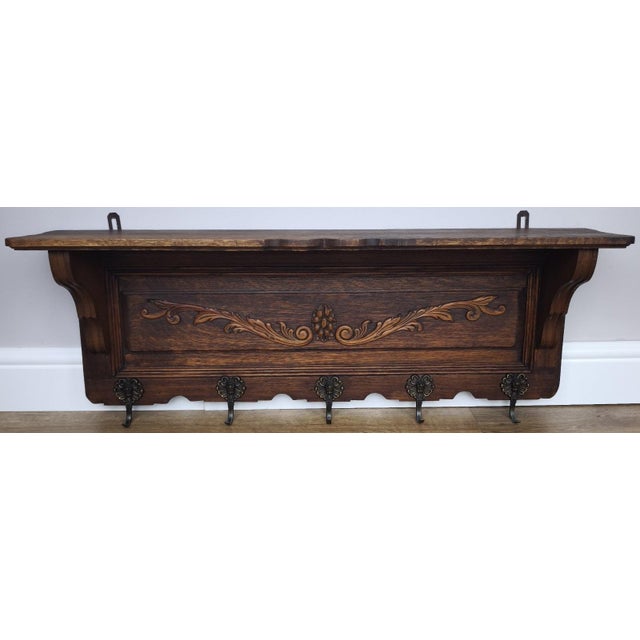 A charming Vintage French coat hanger, beautifully crafted with a warm oak finish and elegant carved detailing across the...