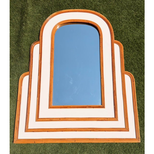 This monumental mirror stands out for its imposing sculptural presence and dynamic volumetric design. Its triple-arched,...