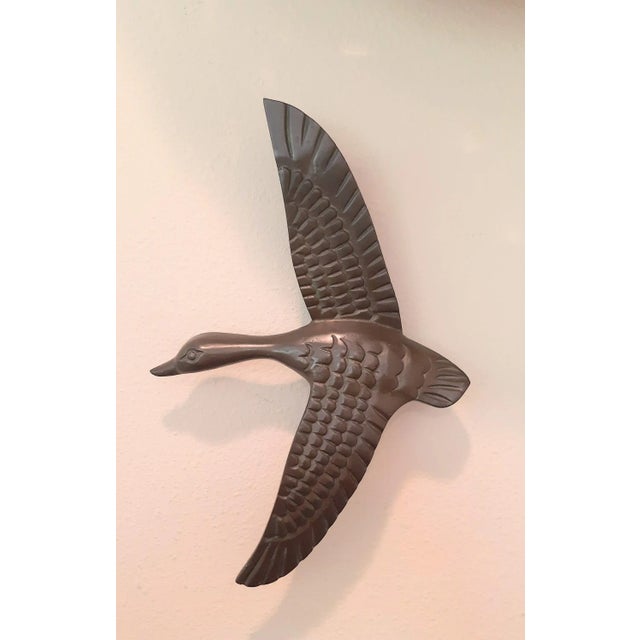 Solid vintage brass flying goose door knocker. Retains original non polished patina. Weighs almost two pounds, solid brass...