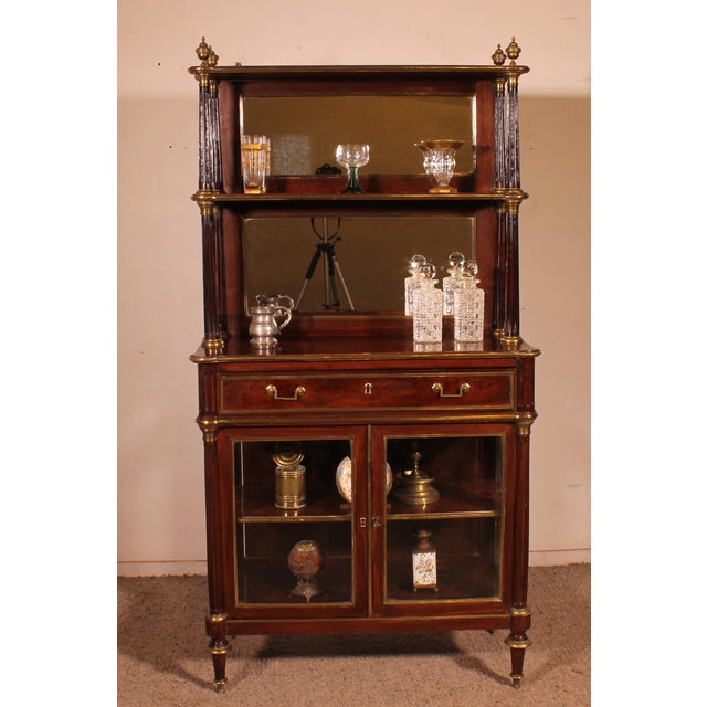 Exquisite and rare Louis XVI period display cabinet or bar from the late 18th century. This beautiful cabinet features two...