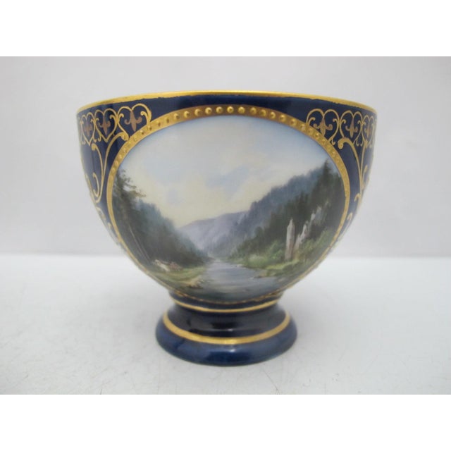 19th century, Karlsbad Hermann Voigt, Bohemia porcelain cup and saucer. Cobalt blue with ornate gilt accents and finely...