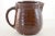 Vintage, warm brown, rustic farmhouse ribbed stoneware pitcher, circa 1930. Marked with an embossed Maple Leaf with a “W,...