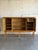 This large oak sideboard in style of Henning Kjærnulf presents a balanced four-door facade. Two central leaded glass doors...