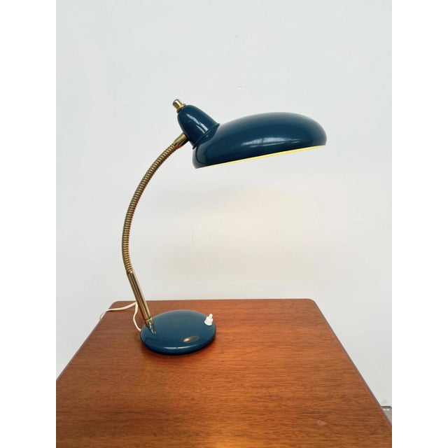 Adjustable table lamp from the 1960s, with a deep duck-egg blue glazed ceramic base and a flexible gold-tone metal arm...